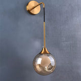 Applique murale pendante dorée avec boule de verre ambre ou gris fumé